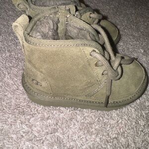 Little boy green laced up Uggs
